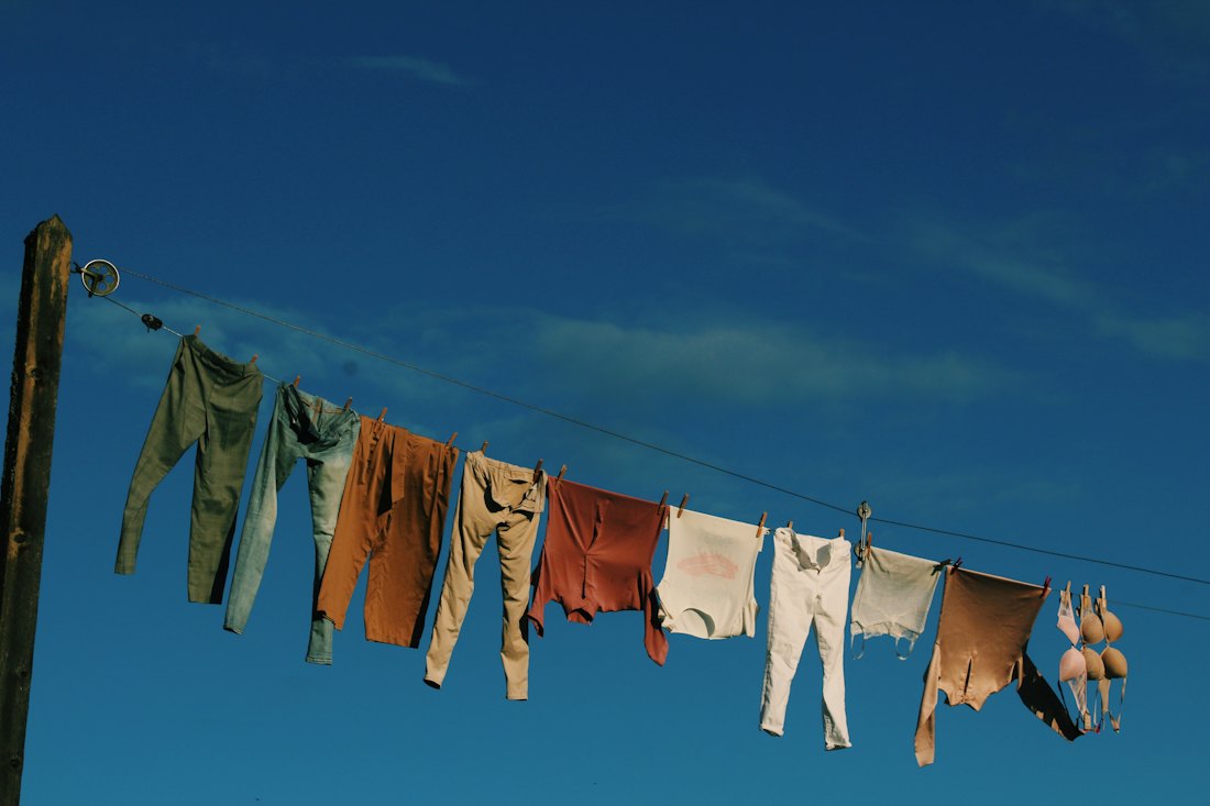 A line of washing drying against a deep blue sky